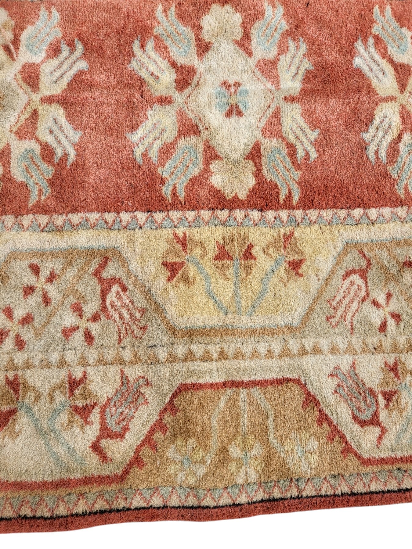 Handmade Turkish Milas wool rug measuring 120cm x 206cm. Central Salmon panel having three diamond shaped medallions