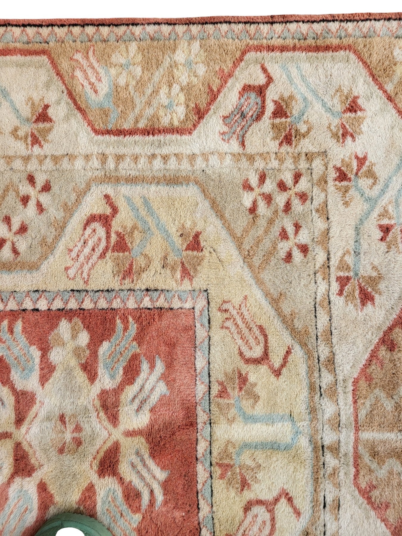 Handmade Turkish Milas wool rug measuring 120cm x 206cm. Central Salmon panel having three diamond shaped medallions