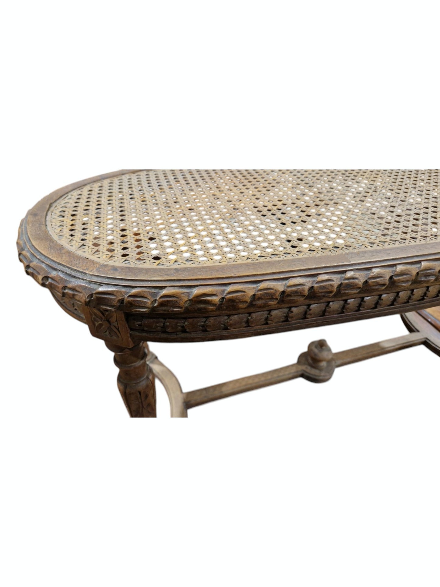 French walnut oval window seat in the Louis XVI-style with cane panel seat, carved frieze and raised