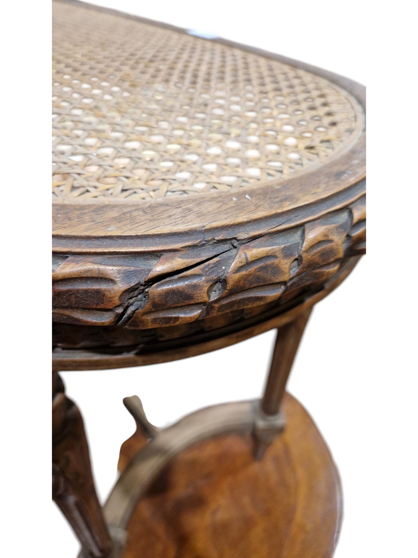 French walnut oval window seat in the Louis XVI-style with cane panel seat, carved frieze and raised