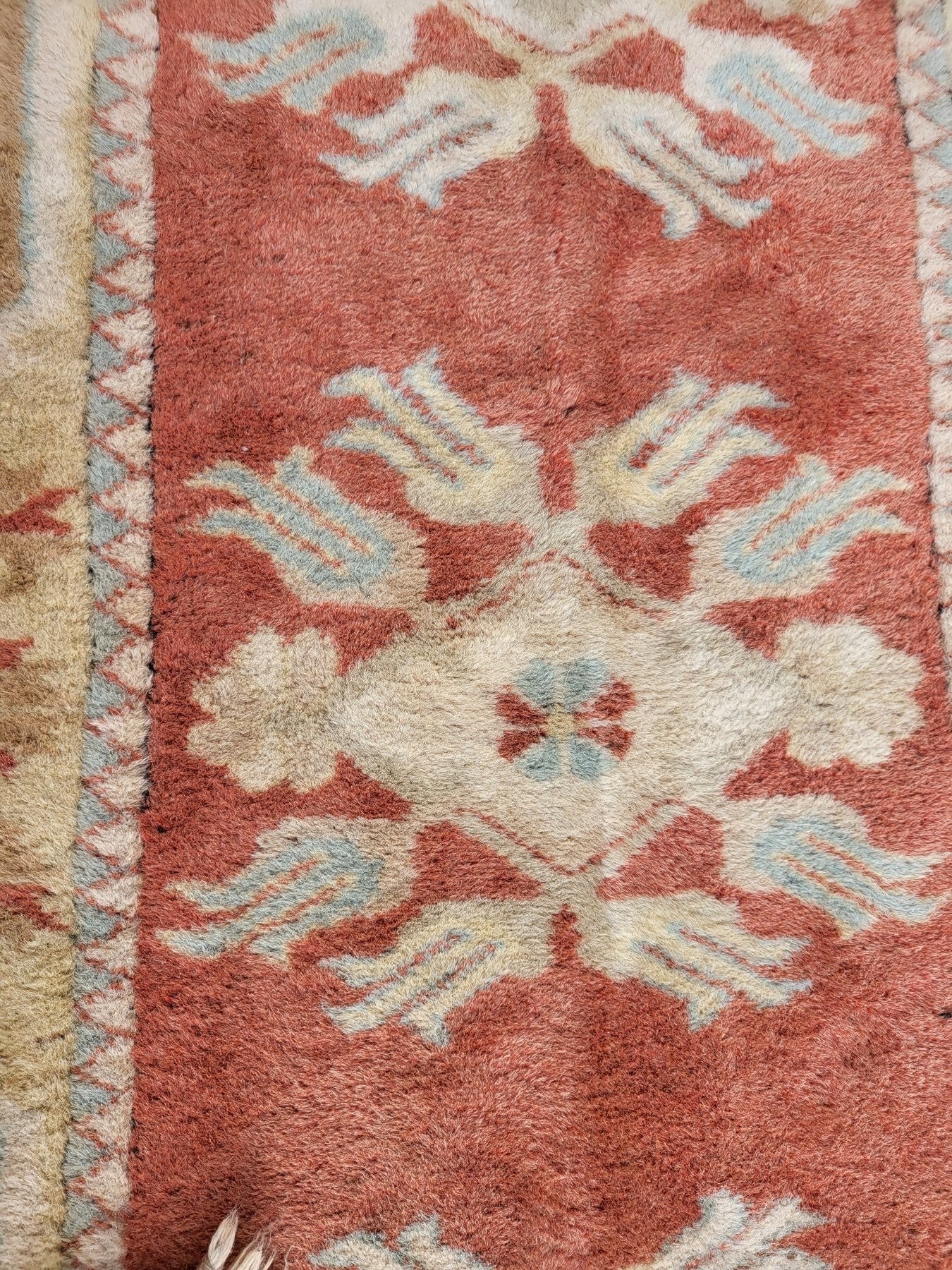 Handmade Turkish Milas wool rug measuring 120cm x 206cm. Central Salmon panel having three diamond shaped medallions