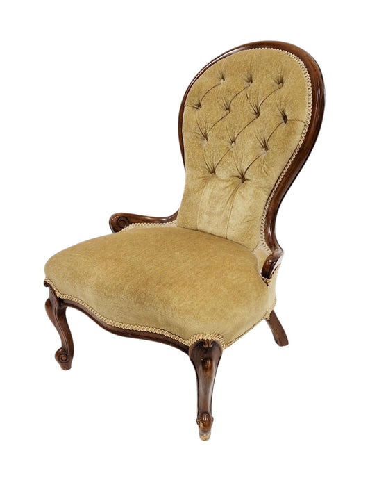 Victorian mahogany framed button back salon chair with yellow upholstery and raised on scrolling