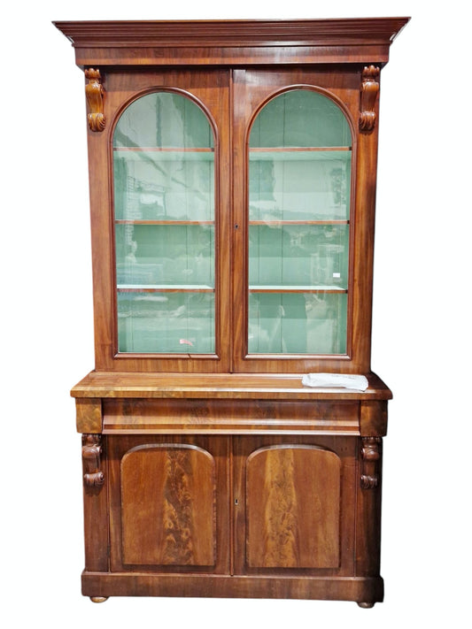 Victorian mahogany library bookcase cupboard, the moulded cornice over two arched glazed doors