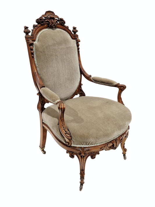 Victorian walnut framed salon chair, the domed top rail with shell and floral carved cresting, green