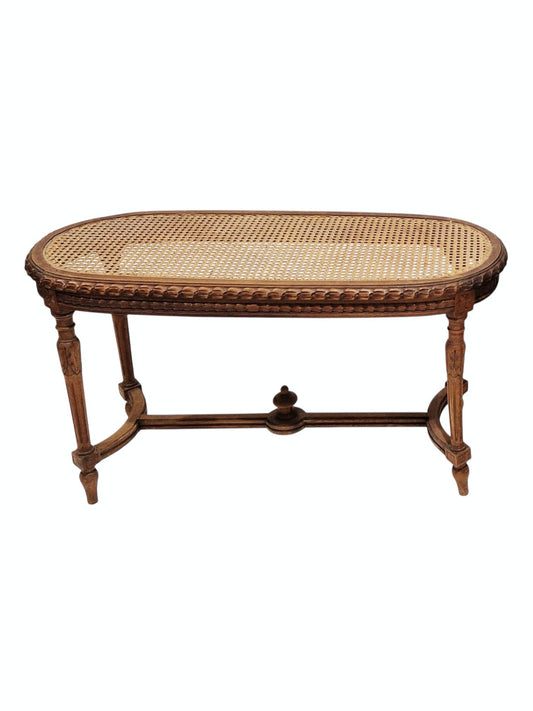 French walnut oval window seat in the Louis XVI-style with cane panel seat, carved frieze and raised